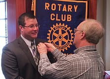 Jason Walker receives his Rotary Pin From Jim Evers