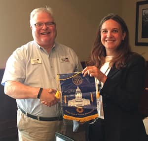 Jim Ogle presents Topeka Rotary flag to Lawrence Central Rotary.