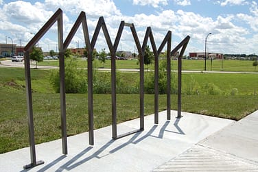 The backstage rack suggests actors holding hands and bending downward in a company bow at the end of a performance.