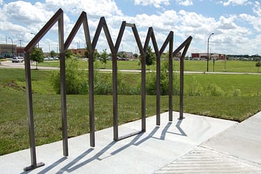 The backstage rack suggests actors holding hands and bending downward in a company bow at the end of a performance.
